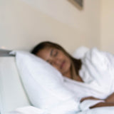 Image showing the face of sleeping woman on her side, getting a restful sleep.